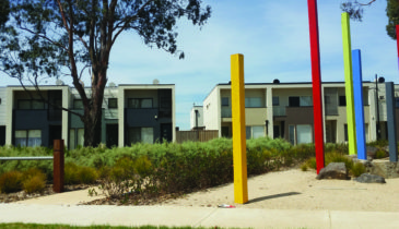 Playground with medium density townhouses in the background