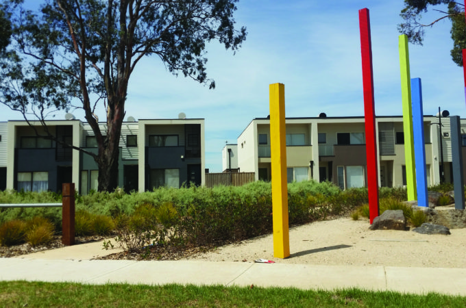 Playground with medium density townhouses in the background