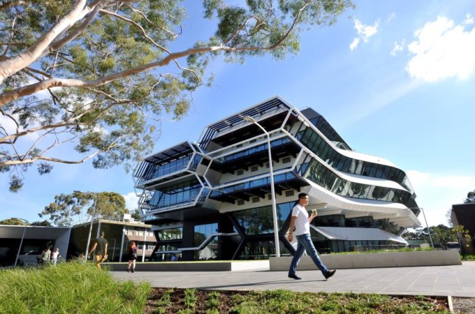 Exterior of Parkville campus with people walking and a multi-storey building in the background