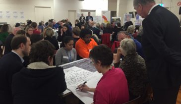 Community room filled with people discussing the Arden precinct through an engagement process
