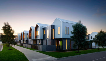 Medium density townhouses with a wide footpath and a vegetation strip at the front