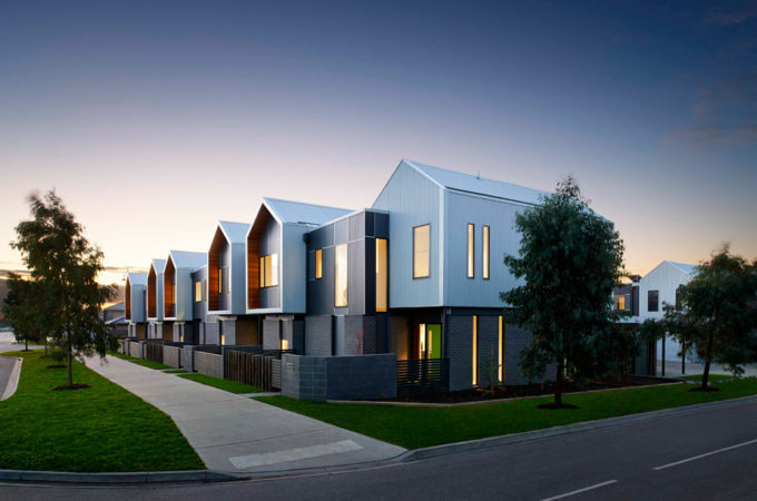 Medium density townhouses with a wide footpath and a vegetation strip at the front