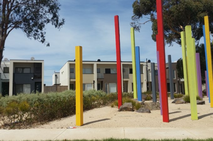 Playground wooden sculptures with medium density townhouses in the background