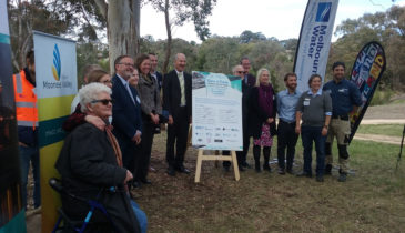 People standing around a easel relating to the Moonee Ponds Creek plan