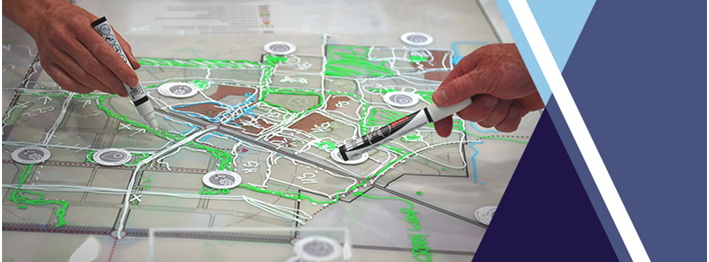Photo of hands pointing at a workshop map within a banner